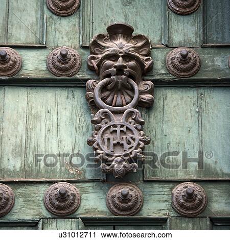 Stock Image - Door knob and rivets on a door, Templo De La Compania De Jesus, Cuzco, Peru. Fotosearch