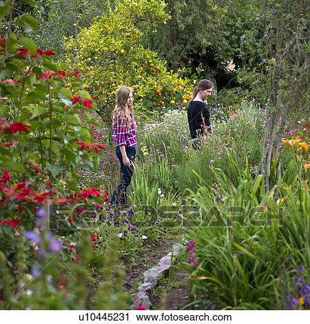 Stock Image - Friends in the garden of Willka Tika Guesthouse, Willka Tika, Sacred Valley, Cusco Region, Peru. Fotosearch