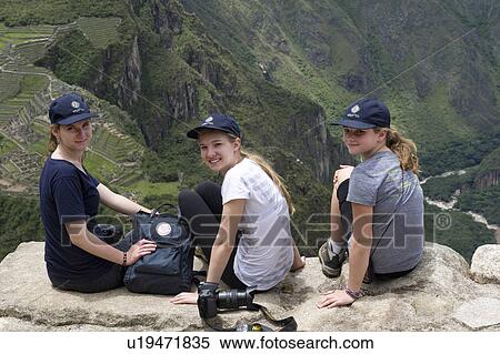 Friends sitting on a cliff with Wayna Picchu and The Lost City of The Incas in the background, Machu Picchu, Cusco Region, Peru View Large Photo Image Stock Photography - Friends sitting on a cliff with Wayna Picchu and The Lost City of The Incas in the background, Machu Picchu, Cusco Region, Peru. Fotosearch
