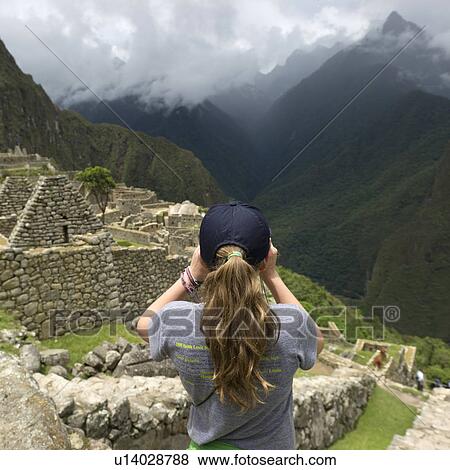 Stock Photo - Girl photographing at The Lost City of The Incas, Machu Picchu, Cusco Region, Peru. Fotosearch