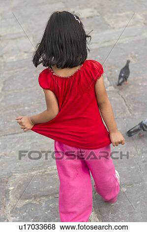 Stock Photo - Girl playing with pigeons, Historic Centre of Lima, Lima, Peru. Fotosearch