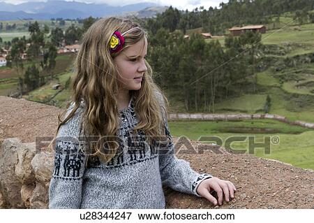 Girl standing on a roof and looking at view, Chinchero, Sacred Valley, Cusco Region, Peru View Large Photo Image Stock Photo - Girl standing on a roof and looking at view, Chinchero, Sacred Valley, Cusco Region, Peru. Fotosearch