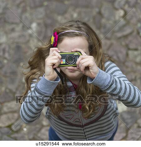Picture - Girl taking a picture at Museo de Arte Precolombino, Cuzco, Peru. Fotosearch