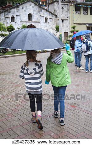 Girls sheltering under an umbrella, Peru View Large Photo Image Stock Photography - Girls sheltering under an umbrella, Peru. Fotosearch