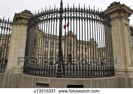 Stock Image - Government Palace viewed through railing, Plaza Mayor, Historic Centre of Lima, Lima, Peru. Fotosearch