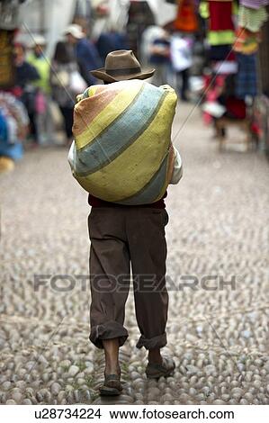 Man walking in a market, Pisac, Sacred Valley, Cusco Region, Peru View Large Photo Image Picture - Man walking in a market, Pisac, Sacred Valley, Cusco Region, Peru. Fotosearch