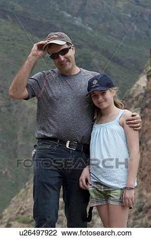 Man with arm around her daughter with Sacred Valley in the background, Peru View Large Photo Image Stock Image - Man with arm around her daughter with Sacred Valley in the background, Peru. Fotosearch
