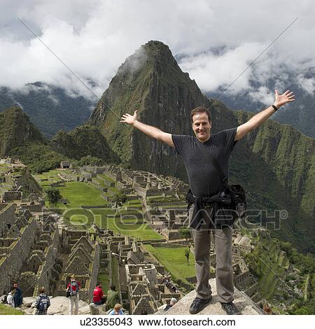 Man with his arm outstretched at The Lost City of The Incas, Machu Picchu, Cusco Region, Peru View Large Photo Image Stock Image - Man with his arm outstretched at The Lost City of The Incas, Machu Picchu, Cusco Region, Peru. Fotosearch