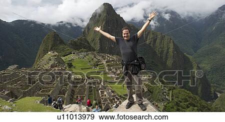 Man with his arm outstretched at The Lost City of The Incas, Machu Picchu, Cusco Region, Peru View Large Photo Image Stock Photo - Man with his arm outstretched at The Lost City of The Incas, Machu Picchu, Cusco Region, Peru. Fotosearch