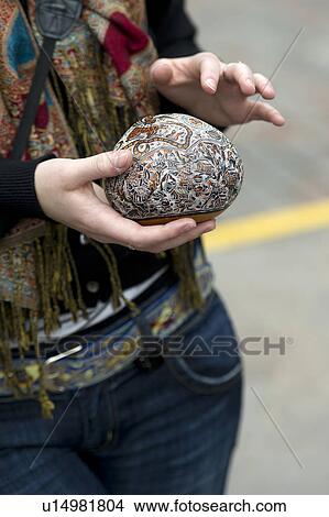 Mid section view of a woman holding a craft product in Plaza Regocijo, Cuzco, Peru View Large Photo Image Picture - Mid section view of a woman holding a craft product in Plaza Regocijo, Cuzco, Peru. Fotosearch