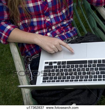 Stock Photo - Mid section view of a woman using a laptop, Willka Tika Guesthouse, Willka Tika, Sacred Valley, Cusco Region, Peru. Fotosearch