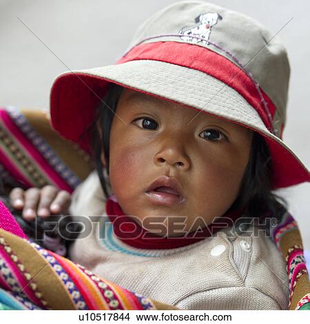 Picture - Portrait of a baby wearing a hat, Sacred Valley, Cusco Region, Peru. Fotosearch