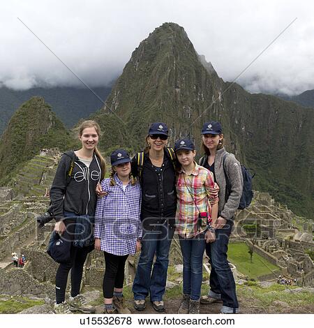 Stock Photo - Portrait of a family with The Lost City of The Incas in the background, Machu Picchu, Cusco Region, Peru. Fotosearch