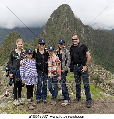 Stock Photo - Portrait of a family with The Lost City of The Incas in the background, Machu Picchu, Cusco Region, Peru. Fotosearch