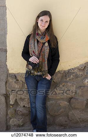 Stock Photo - Portrait of a woman leaning against a stone wall, Barrio de San Blas, Cuzco, Peru. Fotosearch