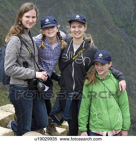 Stock Photography - Portrait of a woman with her sisters at The Lost City of The Incas, Machu Picchu, Cusco Region, Peru. Fotosearch