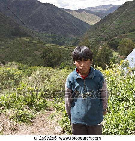 Quechua Indian boy standing with valley in the background, Chumpepoke Primary School, Poques, Sacred Valley, Cusco Region, Peru View Large Photo Image Stock Photograph - Quechua Indian boy standing with valley in the background, Chumpepoke Primary School, Poques, Sacred Valley, Cusco Region, Peru. Fotosearch