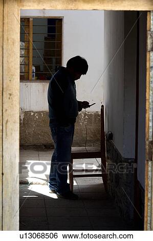 Stock Photograph - Silhouette of a man in a house, Barrio De San Blas, Cuzco, Peru. Fotosearch