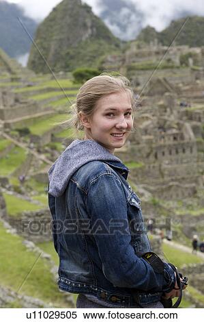 Stock Photography - Teenage girl at The Lost City of The Incas, Machu Picchu, Cusco Region, Peru. Fotosearch