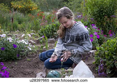 Stock Photography - Teenage girl in the garden of Willka Tika Guesthouse, Willka Tika, Sacred Valley, Cusco Region, Peru. Fotosearch