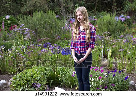 Stock Image - Teenage girl standing in the garden of Willka Tika Guesthouse, Willka Tika, Sacred Valley, Cusco Region, Peru. Fotosearch
