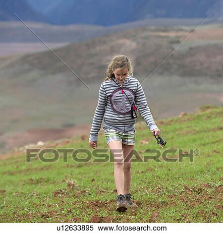 Stock Photography - Teenage girl walking in a field, Sacred Valley, Cusco Region, Peru. Fotosearch