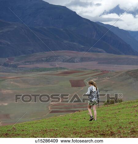 Teenage girl walking in a field with Sacred Valley in the background, Cusco Region, Peru View Large Photo Image Stock Photo - Teenage girl walking in a field with Sacred Valley in the background, Cusco Region, Peru. Fotosearch