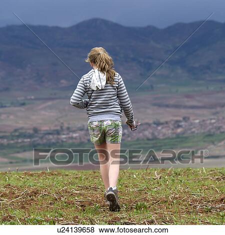 Teenage girl walking in a field with Sacred Valley in the background, Cusco Region, Peru View Large Photo Image Stock Photo - Teenage girl walking in a field with Sacred Valley in the background, Cusco Region, Peru. Fotosearch