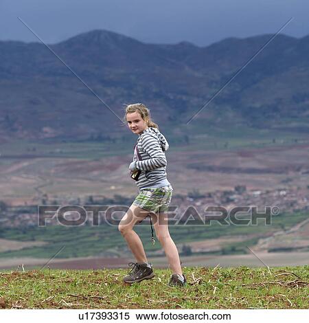 Teenage girl walking in a field with Sacred Valley in the background, Cusco Region, Peru View Large Photo Image Stock Photography - Teenage girl walking in a field with Sacred Valley in the background, Cusco Region, Peru. Fotosearch