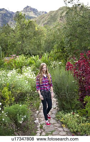 Stock Photo - Teenage girl walking in the garden of Willka Tika Guesthouse, Willka Tika, Sacred Valley, Cusco Region, Peru. Fotosearch