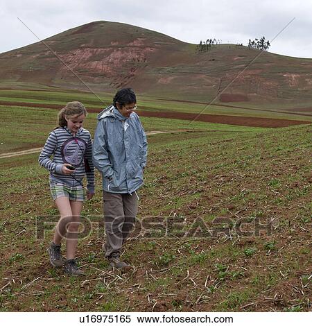 Stock Photography - Teenage girl with her friend walking in Sacred Valley, Cusco Region, Peru. Fotosearch