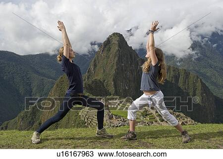 Teenage girls doing warrior 1 pose with The Lost City of The Incas in the background, Machu Picchu, Cusco Region, Peru View Large Photo Image Stock Image - Teenage girls doing warrior 1 pose with The Lost City of The Incas in the background, Machu Picchu, Cusco Region, Peru. Fotosearch