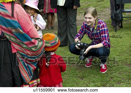 Tourist taking picture of Quechua Indian people, Chumpepoke Primary School, Poques, Sacred Valley, Cusco Region, Peru View Large Photo Image Stock Image - Tourist taking picture of Quechua Indian people, Chumpepoke Primary School, Poques, Sacred Valley, Cusco Region, Peru. Fotosearch