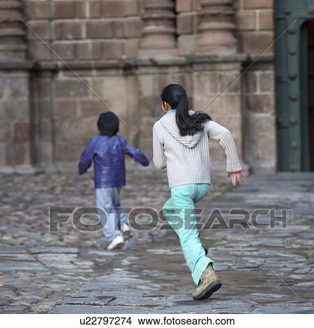 Picture - Two children playing, Plaza de Armas, Cuzco, Peru. Fotosearch