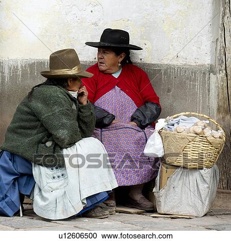 Two women sitting along the street, Sacred Valley, Cusco Region, Peru View Large Photo Image Stock Image - Two women sitting along the street, Sacred Valley, Cusco Region, Peru. Fotosearch