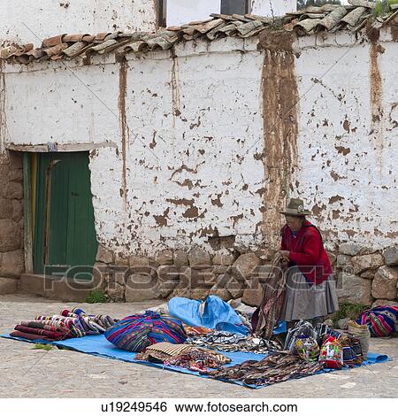 Vendor selling traditional products at a market stall, Chinchero, Sacred Valley, Cusco Region, Peru View Large Photo Image Stock Photograph - Vendor selling traditional products at a market stall, Chinchero, Sacred Valley, Cusco Region, Peru. Fotosearch