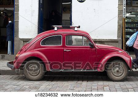 Stock Image - Vintage car on a street in Cuzco, Peru. Fotosearch