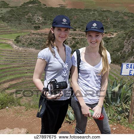 Stock Photography - Woman and a teenage girl with Incan agricultural terraces in the background, Moray, Machu Picchu, Cusco Region, Peru. Fotosearch