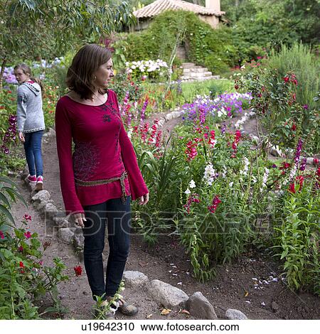 Stock Image - Woman and her daughter walking in the garden of Willka Tika Guesthouse, Willka Tika, Sacred Valley, Cusco Region, Peru. Fotosearch