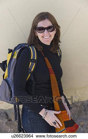 Woman carrying backpack and smiling, Barrio de San Blas, Cuzco, Peru View Large Photo Image Picture - Woman carrying backpack and smiling, Barrio de San Blas, Cuzco, Peru. Fotosearch