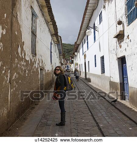 Woman carrying backpack and standing in a street of Barrio de San Blas, Cuzco, Peru View Large Photo Image Stock Photography - Woman carrying backpack and standing in a street of Barrio de San Blas, Cuzco, Peru. Fotosearch