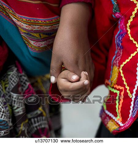 Woman holding hands of her child, Cuzco, Peru View Large Photo Image Stock Image - Woman holding hands of her child, Cuzco, Peru. Fotosearch