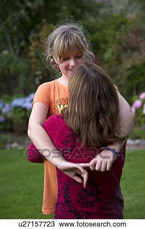 Stock Image - Woman hugging her daughter in the garden of Willka Tika Guesthouse, Willka Tika, Sacred Valley, Cusco Region, Peru. Fotosearch