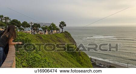 Picture - Woman looking at ocean, Av De La Aviacion, Miraflores District, Lima Province, Peru. Fotosearch