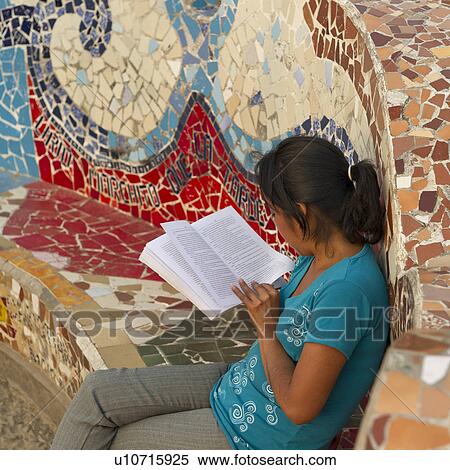 Stock Photography - Woman reading a book in a park, El Parque Del Amor, Av De La Aviacion, Miraflores District, Lima Province, Peru. Fotosearch
