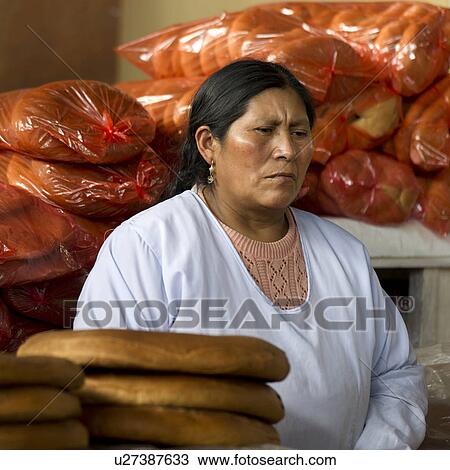 Stock Image - Woman selling bread at Mercado Central, Cuzco, Peru. Fotosearch