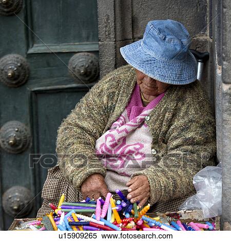 Woman selling candles at a market stall, Cuzco, Peru View Large Photo Image Stock Photography - Woman selling candles at a market stall, Cuzco, Peru. Fotosearch