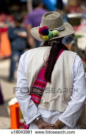 Stock Image - Woman shopping in a market, Pisac, Sacred Valley, Cusco Region, Peru. Fotosearch