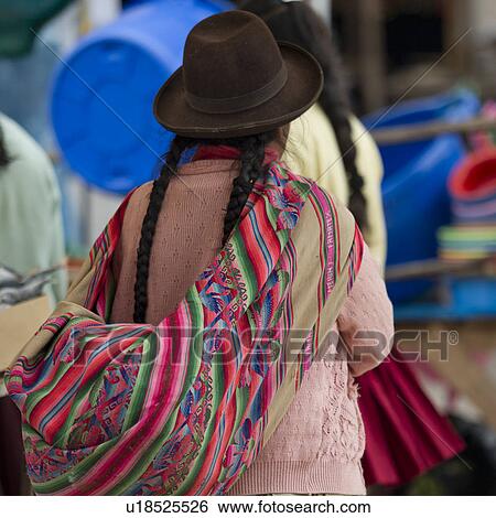 Stock Photograph - Woman shopping in a market, Pisac, Sacred Valley, Cusco Region, Peru. Fotosearch