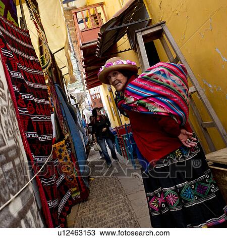 Stock Image - Woman standing at Sunday market, Pisac, Cuzco, Peru. Fotosearch